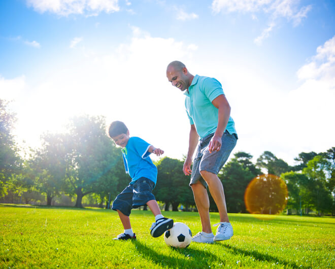 stockphoto19966198fatherandsonplayingfootballtogether1